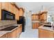 Kitchen with wood cabinets, tile backsplash, and stainless steel appliances at 2181 Via Seville, Punta Gorda, FL 33950