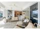 Bright lanai with a wicker sofa set, ceiling fan, tile floor, and views into the kitchen at 2181 Via Seville, Punta Gorda, FL 33950