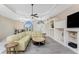 Bright living room featuring a large sectional sofa, coffered ceilings, and built-in shelving at 2181 Via Seville, Punta Gorda, FL 33950