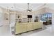 Open living room with a fan, tv, built-in shelving, and sliding doors leading to the backyard at 2181 Via Seville, Punta Gorda, FL 33950