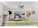 Spacious living room with backyard views, a ceiling fan, built-in shelving, and an open layout at 2181 Via Seville, Punta Gorda, FL 33950