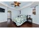 Light-filled main bedroom with hardwood floors, access to an ensuite bathroom, and comfortable furnishings at 2181 Via Seville, Punta Gorda, FL 33950