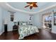 Comfortable bedroom featuring a decorative ceiling, stylish fan, and sliding glass doors to the patio at 2181 Via Seville, Punta Gorda, FL 33950