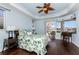 Spacious main bedroom with a ceiling fan, hardwood floors, and outdoor access to a patio at 2181 Via Seville, Punta Gorda, FL 33950