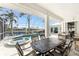 Enclosed patio featuring spa, furniture and view of the pool and canal at 2181 Via Seville, Punta Gorda, FL 33950