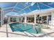 Screened-in pool with a hot tub, outdoor seating, and views of the interior at 2181 Via Seville, Punta Gorda, FL 33950