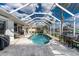 Screened-in pool with a seating area, tiled deck, and view of the canal at 2181 Via Seville, Punta Gorda, FL 33950