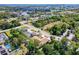 Wide aerial view of houses and landscaping with mature trees and a road nearby at 22490 Westchester Blvd, Punta Gorda, FL 33980