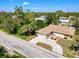 Aerial view of home featuring a pergola, established landscaping, and a driveway at 22490 Westchester Blvd, Punta Gorda, FL 33980