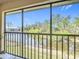 Enjoy serene water views from this condo balcony, surrounded by lush greenery at 25050 Sandhill Blvd # B2 Building 6, Punta Gorda, FL 33983