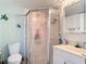 This bathroom offers a shower stall and sink with ocean themed decor at 25050 Sandhill Blvd # B2 Building 6, Punta Gorda, FL 33983