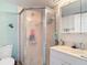 This bathroom offers a shower stall and sink with ocean themed decor at 25050 Sandhill Blvd # B2 Building 6, Punta Gorda, FL 33983