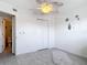 Cozy bedroom with laminate floors, an ocean themed decor, and a view of the ensuite bathroom at 25050 Sandhill Blvd # B2 Building 6, Punta Gorda, FL 33983