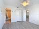 This bedroom offers a view of the bathroom and light-colored wood-look flooring at 25050 Sandhill Blvd # B2 Building 6, Punta Gorda, FL 33983