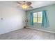 Inviting bedroom featuring a bright window with light blue curtains and fan at 25050 Sandhill Blvd # B2 Building 6, Punta Gorda, FL 33983