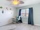 Bright bedroom featuring modern decor, laminate floors, and a window with blackout curtains at 25050 Sandhill Blvd # B2 Building 6, Punta Gorda, FL 33983