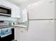Kitchen featuring modern appliances, white cabinetry, and ample counter space at 25050 Sandhill Blvd # B2 Building 6, Punta Gorda, FL 33983