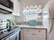 Cozy kitchen featuring white cabinetry, marble countertops, and updated appliances at 25050 Sandhill Blvd # B2 Building 6, Punta Gorda, FL 33983