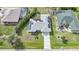 Aerial view of a house featuring solar panels, screened-in pools, and a well-maintained landscape at 25069 Bolivar Dr, Punta Gorda, FL 33983