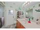 Bright bathroom showcasing a walk-in shower, fish decor, and wooden cabinets, offering a clean, stylish space at 25069 Bolivar Dr, Punta Gorda, FL 33983