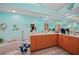 A bathroom with a bathtub, wooden cabinets, and a large mirror, creating a bright and functional space at 25069 Bolivar Dr, Punta Gorda, FL 33983