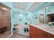 Bright bathroom with jacuzzi tub, glass shower, and wooden vanity at 25069 Bolivar Dr, Punta Gorda, FL 33983