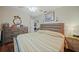 Bright bedroom showcasing hardwood floors, ceiling fan, and wooden furniture for a warm and inviting ambiance at 25069 Bolivar Dr, Punta Gorda, FL 33983