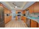 Bright eat-in kitchen with stainless steel appliances, plenty of cabinets and counter space, and stylish ceiling fan at 25069 Bolivar Dr, Punta Gorda, FL 33983