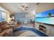 Comfortable living area features light blue accent wall and a beach-themed rug at 25069 Bolivar Dr, Punta Gorda, FL 33983