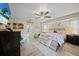 Main bedroom with wood floors, ceiling fan, and a comfortable bed at 25069 Bolivar Dr, Punta Gorda, FL 33983