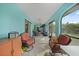 A charming sunroom with plenty of natural light, comfortable seating, and a ceiling fan for relaxation at 25069 Bolivar Dr, Punta Gorda, FL 33983