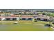 Aerial view of waterfront condos with a lake view, landscaped grounds, and boat dock at 25275 Rampart Blvd # 1602, Punta Gorda, FL 33983