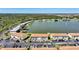 Scenic aerial view showcasing the condo complex, lush landscaping, and a serene lake at 25275 Rampart Blvd # 1602, Punta Gorda, FL 33983