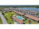Aerial shot of community with a pool, lake and mature landscaping and well-maintained lawns at 25275 Rampart Blvd # 1602, Punta Gorda, FL 33983
