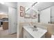 Bathroom with a white sink vanity with a marble countertop, framed mirror, and neutral color walls at 25275 Rampart Blvd # 1602, Punta Gorda, FL 33983