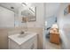Bathroom with a white vanity and sink with a glimpse into an adjacent bedroom at 25275 Rampart Blvd # 1602, Punta Gorda, FL 33983