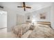 Bright bedroom with twin beds, flamingo artwork, ceiling fan and closet at 25275 Rampart Blvd # 1602, Punta Gorda, FL 33983