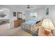 Serene bedroom featuring a comfortable bed, dresser, and view into living area at 25275 Rampart Blvd # 1602, Punta Gorda, FL 33983