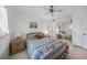 Cozy bedroom featuring a ceiling fan, and seashell-patterned bedding, mirrored wall for an expanded feel at 25275 Rampart Blvd # 1602, Punta Gorda, FL 33983