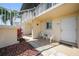 Condo entrance featuring a cozy seating area, white stairs, and charming details that create a welcoming atmosphere at 25275 Rampart Blvd # 1602, Punta Gorda, FL 33983