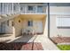 Inviting condo entrance with seating area and well-lit entryway, number 1602, adjacent to an outdoor staircase at 25275 Rampart Blvd # 1602, Punta Gorda, FL 33983