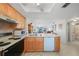 Modern kitchen with a view of the dining area, plenty of cabinets, and updated appliances at 25275 Rampart Blvd # 1602, Punta Gorda, FL 33983