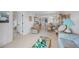 Comfortable living room featuring tile floors, cozy furniture, and an open layout to the kitchen and dining area at 25275 Rampart Blvd # 1602, Punta Gorda, FL 33983