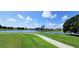 Beautiful community golf course and lake view under a bright blue sky at 26034 Feathersound Dr, Punta Gorda, FL 33955