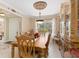 Charming dining room with a large wooden table, decorative china cabinet, and natural light at 3273 Wentworth St, North Port, FL 34288