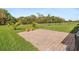 Spacious backyard featuring a brick patio area with landscaped lawn and a fenced perimeter at 3860 Cobblestone Ln, Punta Gorda, FL 33980