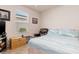Comfortable bedroom with ceiling fan, large window, TV, leather recliner, and storage chest at 3860 Cobblestone Ln, Punta Gorda, FL 33980