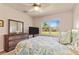Bedroom featuring a comfortable bed, dresser, and window with natural light creating a cozy and relaxing space at 3860 Cobblestone Ln, Punta Gorda, FL 33980