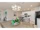 Dining area featuring a chandelier, table, kitchen in background, and beige walls at 3860 Cobblestone Ln, Punta Gorda, FL 33980