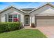 Charming single-story home with a well-manicured lawn, brick paver walkway and a two car garage at 3860 Cobblestone Ln, Punta Gorda, FL 33980